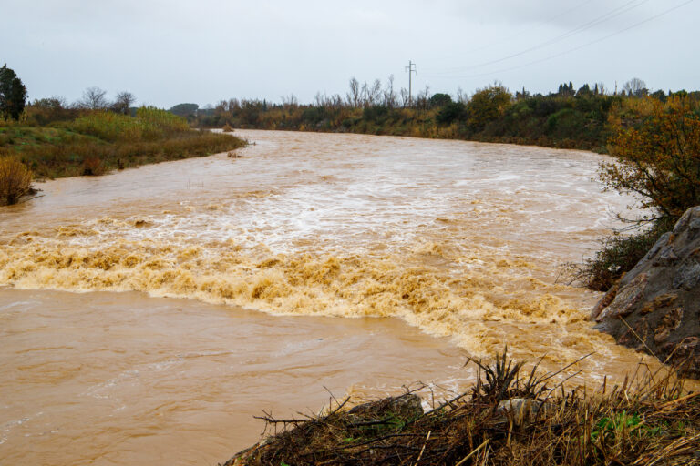 Rivière en crue après un épisode de fortes pluies, avec un débit important et des eaux boueuses illustrant le risque d'inondation sur le territoire de Théza.